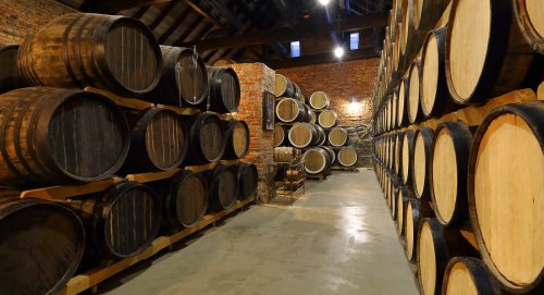 Rows Of Alcoholic Barrels Are Kept In Stock. Distillery. Cognac, Rows of alcoholic barrels are kept in stock. Distillery. Cognac, whiskey, wine, brandy. Alcohol in barrels, alcohol storage